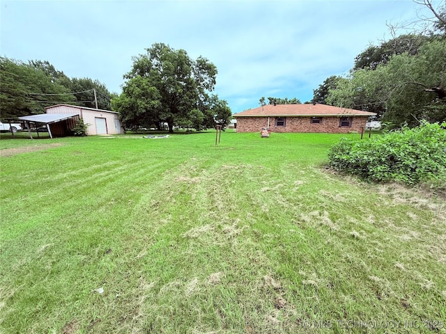 303 N 6th, Calera, OK 74730 - view of grassy yard with a detached garage and an outdoor structure