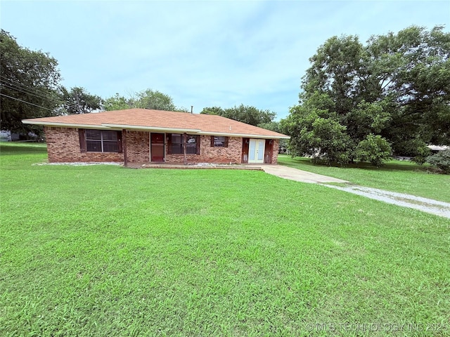 303 N 6th, Calera, OK 74730 - ranch-style home with a front lawn and brick siding