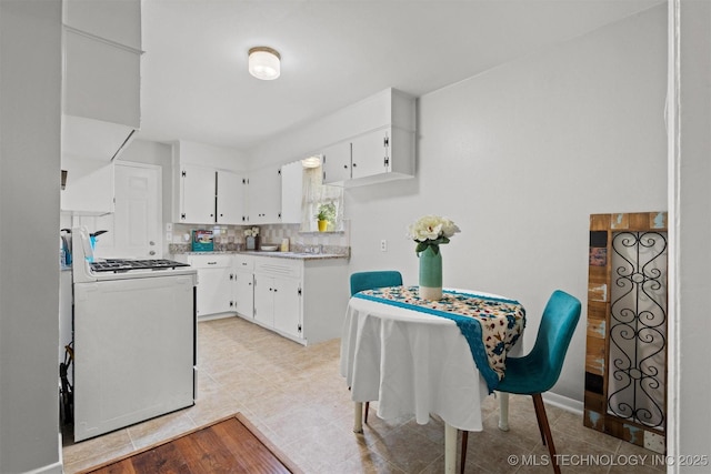 707 Bradwell St, Colbert, OK 74733 - kitchen with gas range gas stove, white cabinets, light countertops, decorative backsplash, and light tile patterned floors