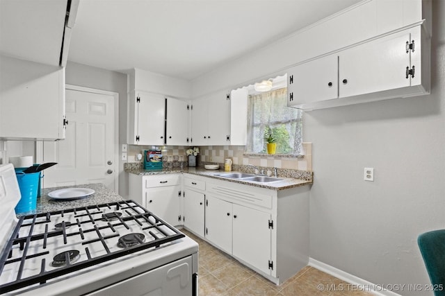 707 Bradwell St, Colbert, OK 74733 - kitchen with white gas range, white cabinets, light tile patterned floors, and tasteful backsplash