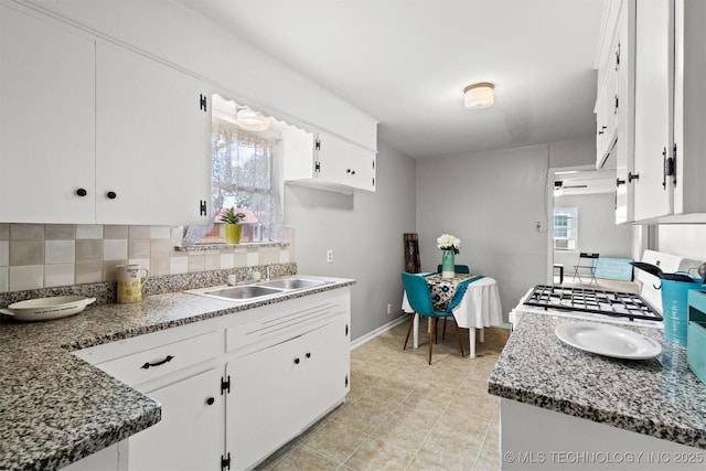 707 Bradwell St, Colbert, OK 74733 - kitchen featuring tasteful backsplash, white cabinets, range, light tile patterned floors, and stone counters