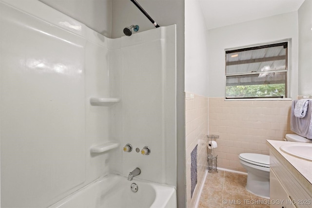 707 Bradwell St, Colbert, OK 74733 - bathroom with vanity, tile patterned floors, tub / shower combination, and tile walls