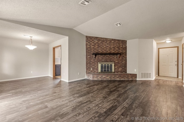 9207 S 92nd E Ave, Tulsa, OK 74133 - unfurnished living room with a fireplace, wood finished floors, a textured ceiling, and lofted ceiling
