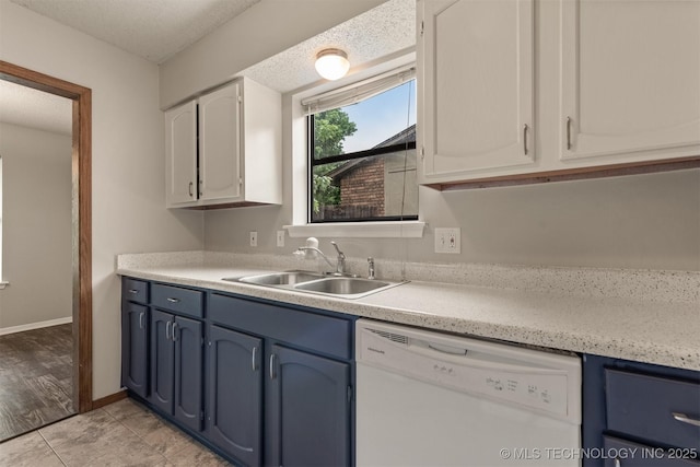 9207 S 92nd E Ave, Tulsa, OK 74133 - kitchen featuring dishwasher, blue cabinetry, light countertops, white cabinetry, and a textured ceiling