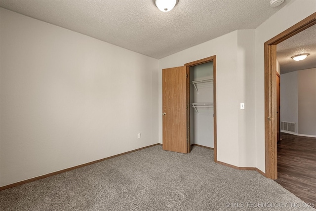 9207 S 92nd E Ave, Tulsa, OK 74133 - unfurnished bedroom featuring a textured ceiling, carpet, and a closet