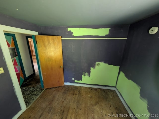 468446 E 908th Rd, Bunch, OK 74931 - unfurnished bedroom featuring wood finished floors