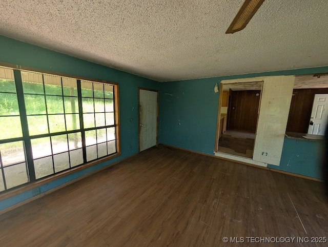 468446 E 908th Rd, Bunch, OK 74931 - spare room with a textured ceiling, wood finished floors, and a ceiling fan