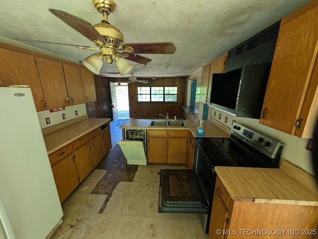 468446 E 908th Rd, Bunch, OK 74931 - kitchen featuring freestanding refrigerator, stainless steel range with electric cooktop, light flooring, dishwashing machine, and brown cabinets