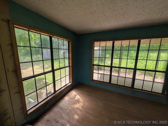 468446 E 908th Rd, Bunch, OK 74931 - empty room with wood finished floors and a textured ceiling