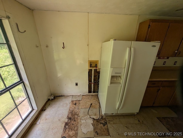 468446 E 908th Rd, Bunch, OK 74931 - kitchen featuring white refrigerator with ice dispenser and brown cabinetry