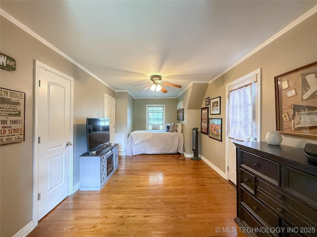 1312 S Oak, Ada, OK 74820 - bedroom with light wood-style floors, ornamental molding, and a ceiling fan