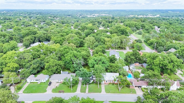1312 S Oak, Ada, OK 74820 - aerial view of property and surrounding area featuring a heavily wooded area