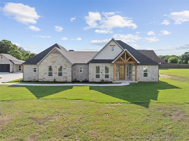 150 Chateau Bnd, Ardmore, OK 73401 - view of front of house with stone siding, a front yard, board and batten siding, and roof with shingles