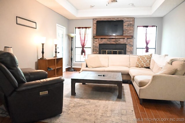 2802 Georgia, Muskogee, OK 74403 - living room with a raised ceiling, wood finished floors, plenty of natural light, and a fireplace