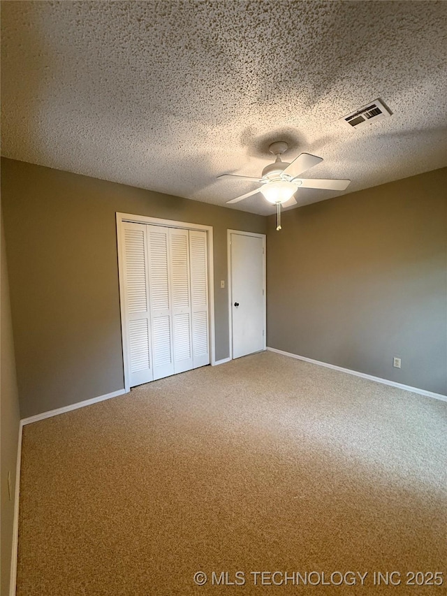 2802 Georgia, Muskogee, OK 74403 - unfurnished bedroom with carpet floors, a closet, ceiling fan, and a textured ceiling