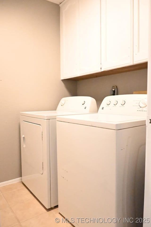 2802 Georgia, Muskogee, OK 74403 - laundry room featuring independent washer and dryer, cabinet space, and light tile patterned floors