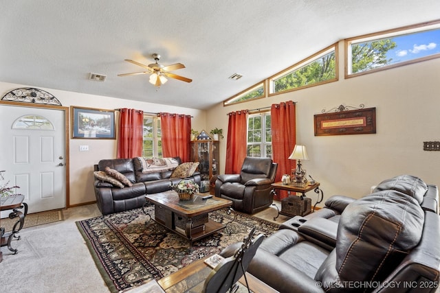 447247 E 70th Rd, Welch, OK 74369 - living room with a ceiling fan, lofted ceiling, carpet, and a textured ceiling