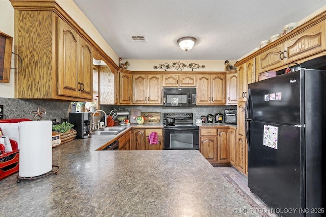 447247 E 70th Rd, Welch, OK 74369 - kitchen with black appliances, tasteful backsplash, brown cabinetry, dark countertops, and a peninsula