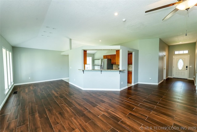 7224 NW 102nd, Oklahoma City, OK 73162 - unfurnished living room with dark wood-style floors, a ceiling fan, lofted ceiling, a textured ceiling, and recessed lighting