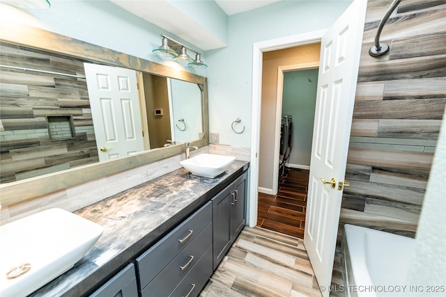 7224 NW 102nd, Oklahoma City, OK 73162 - full bathroom with double vanity, wood finished floors, and a bath