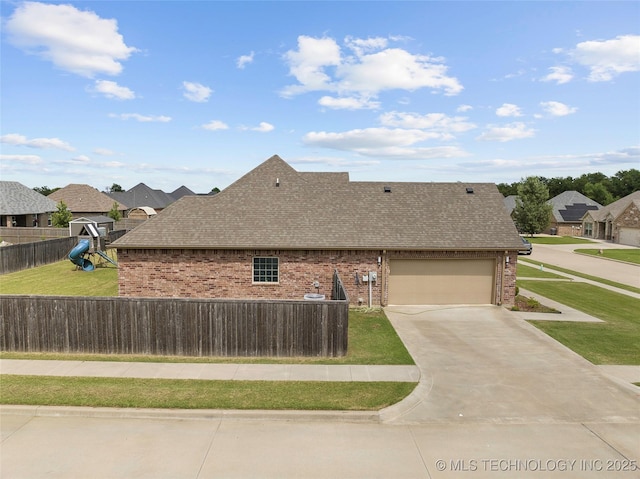 303 Hidden Path, Ardmore, OK 73401 - view of home's exterior featuring roof with shingles, brick siding, concrete driveway, an attached garage, and a playground