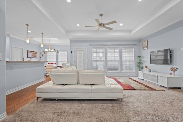 303 Hidden Path, Ardmore, OK 73401 - living area featuring a raised ceiling, a ceiling fan, a chandelier, crown molding, and wood finished floors