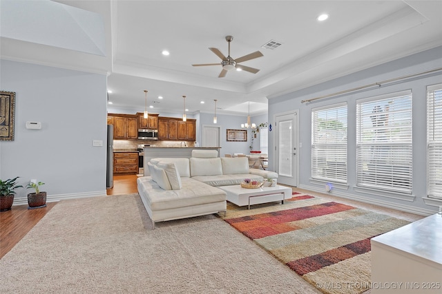 303 Hidden Path, Ardmore, OK 73401 - living area with ceiling fan, recessed lighting, a raised ceiling, ornamental molding, and light wood-style floors