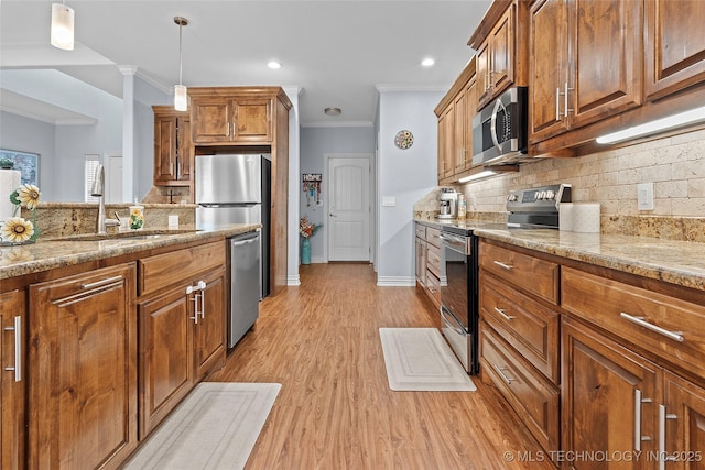 303 Hidden Path, Ardmore, OK 73401 - kitchen featuring appliances with stainless steel finishes, ornamental molding, brown cabinets, light stone countertops, and backsplash