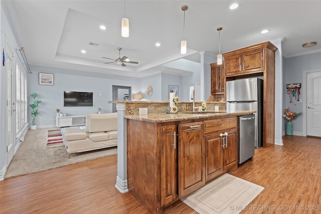 303 Hidden Path, Ardmore, OK 73401 - kitchen with open floor plan, crown molding, stainless steel dishwasher, light wood-style flooring, and brown cabinets