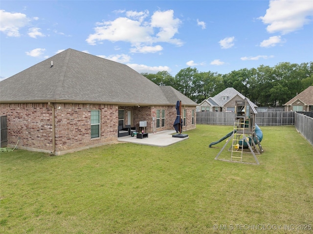 303 Hidden Path, Ardmore, OK 73401 - rear view of property with roof with shingles, a patio area, a fenced backyard, brick siding, and a playground