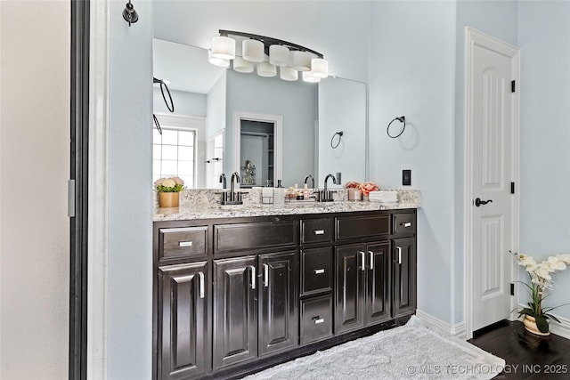 303 Hidden Path, Ardmore, OK 73401 - bathroom with double vanity and baseboards