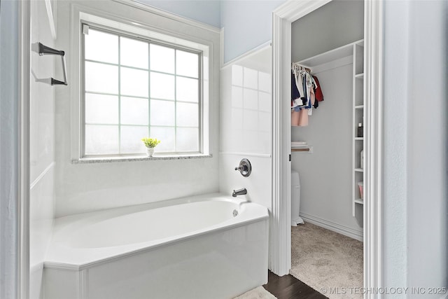 303 Hidden Path, Ardmore, OK 73401 - bathroom featuring a garden tub and a spacious closet