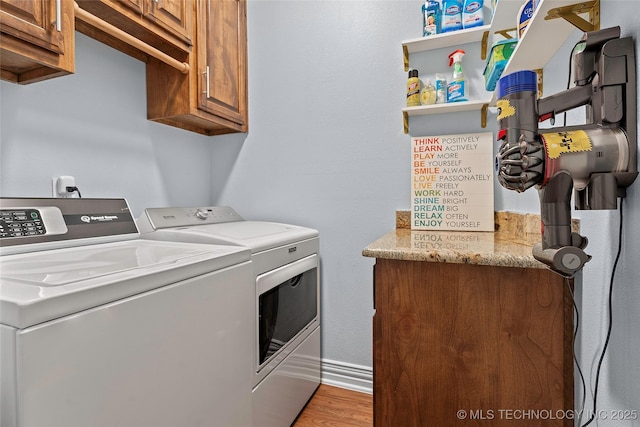 303 Hidden Path, Ardmore, OK 73401 - laundry room featuring washer and clothes dryer, cabinet space, and wood finished floors