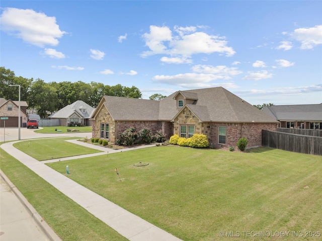 303 Hidden Path, Ardmore, OK 73401 - view of front facade with a shingled roof, stone siding, and brick siding