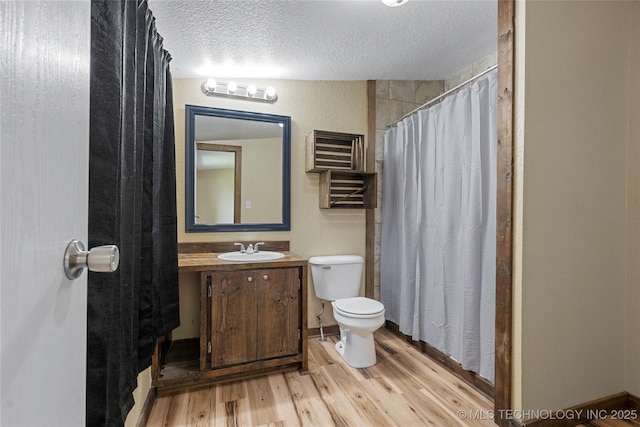 14820 Memorial, Wilson, OK 73463 - full bathroom featuring wood finished floors, a textured ceiling, vanity, and a shower with shower curtain
