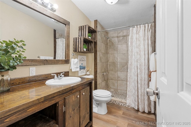 14820 Memorial, Wilson, OK 73463 - bathroom featuring vanity, a tile shower, wood finished floors, and a textured ceiling