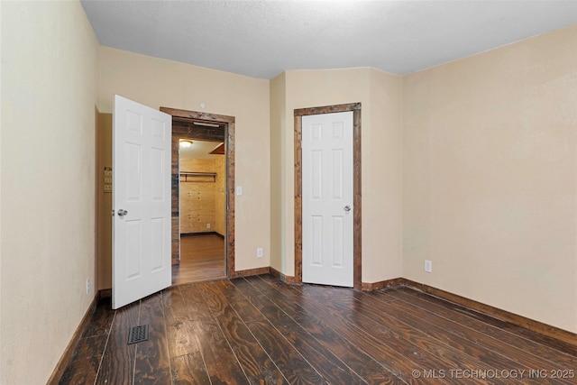 14820 Memorial, Wilson, OK 73463 - unfurnished bedroom featuring dark wood-style floors and baseboards