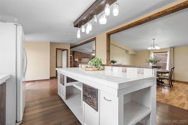 14820 Memorial, Wilson, OK 73463 - kitchen with freestanding refrigerator, light countertops, dark wood finished floors, and a chandelier