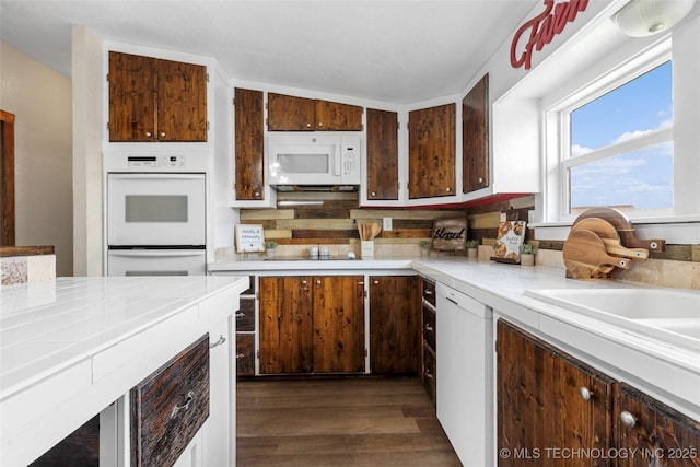 14820 Memorial, Wilson, OK 73463 - kitchen featuring white appliances, dark wood-type flooring, light countertops, and backsplash