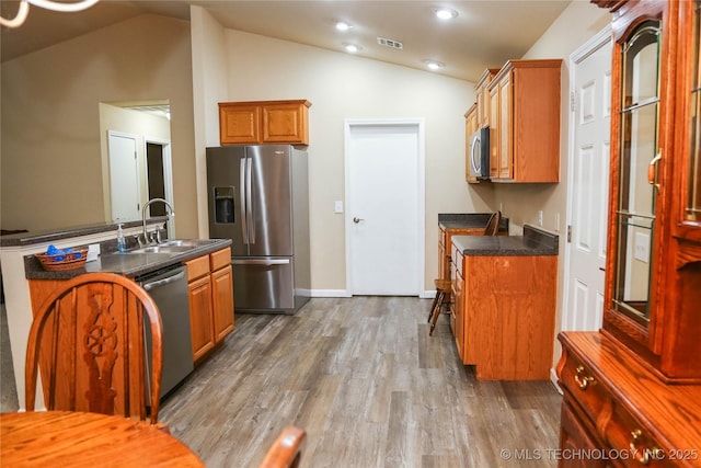 614 S Seminole St, Skiatook, OK 74070 - kitchen featuring appliances with stainless steel finishes, dark countertops, lofted ceiling, wood finished floors, and recessed lighting