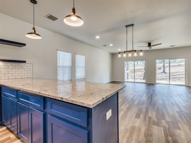 7 Port Duncan Blvd, Afton, OK 74331 - kitchen featuring blue cabinetry, a ceiling fan, a peninsula, light wood-style floors, and recessed lighting