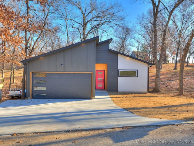 7 Port Duncan Blvd, Afton, OK 74331 - contemporary home featuring board and batten siding, concrete driveway, and a garage