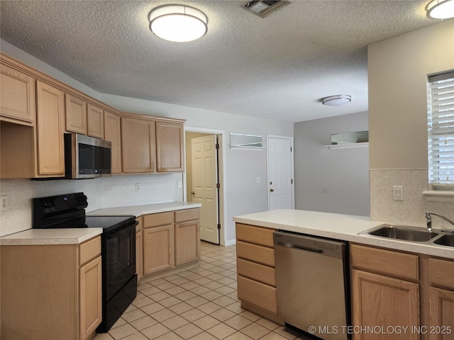9423 S 88th Ave E, Tulsa, OK 74133 - kitchen featuring appliances with stainless steel finishes, a textured ceiling, light countertops, a peninsula, and light brown cabinetry
