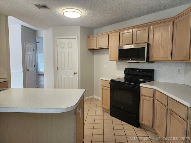 9423 S 88th Ave E, Tulsa, OK 74133 - kitchen featuring black range with electric stovetop, stainless steel microwave, light countertops, and a textured ceiling