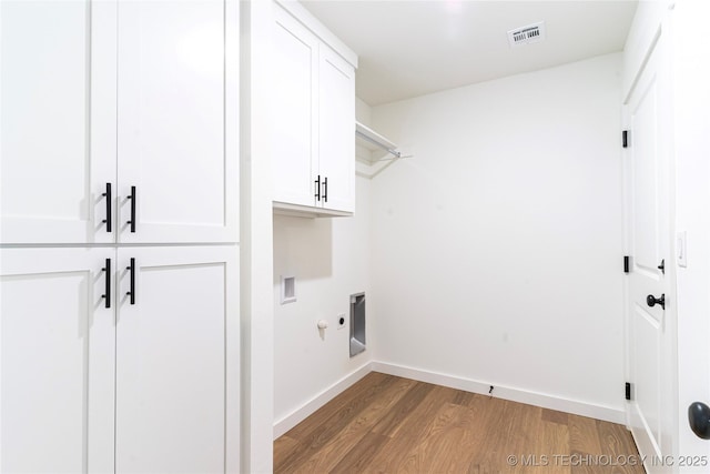 10917 S 271st E Ave, Coweta, OK 74429 - laundry area featuring cabinet space, electric dryer hookup, wood finished floors, and washer hookup