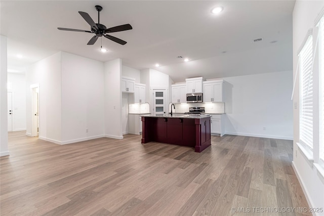 10917 S 271st E Ave, Coweta, OK 74429 - kitchen featuring appliances with stainless steel finishes, ceiling fan, open floor plan, healthy amount of natural light, and vaulted ceiling