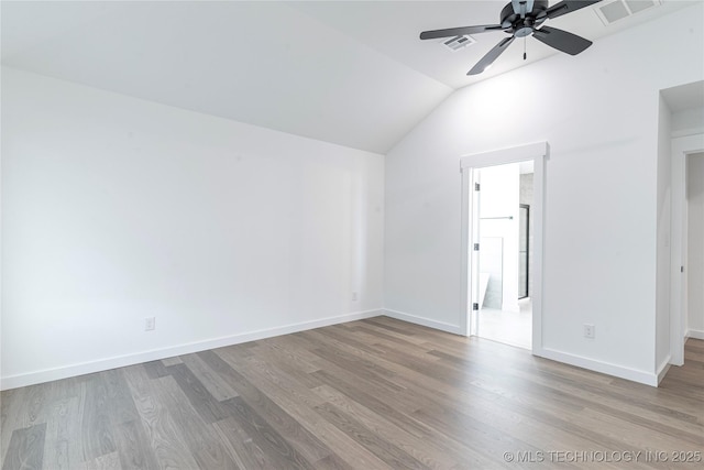 10917 S 271st E Ave, Coweta, OK 74429 - unfurnished bedroom with vaulted ceiling, wood finished floors, connected bathroom, and ceiling fan