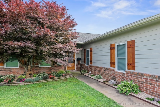 20672 E Kambrie St, Inola, OK 74036 - view of exterior entry featuring brick siding and a lawn