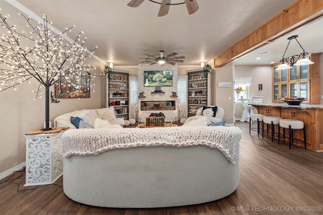 20672 E Kambrie St, Inola, OK 74036 - living room with ceiling fan, dark wood-style flooring, and a fireplace