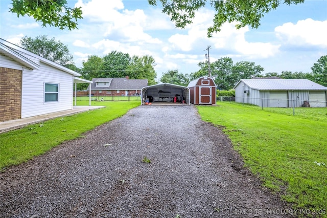 12922 S 123rd E Ave, Broken Arrow, OK 74011 - view of yard featuring a detached carport, a storage unit, and gravel driveway